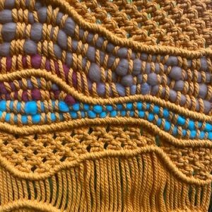 Bright orange macrame wall hanging